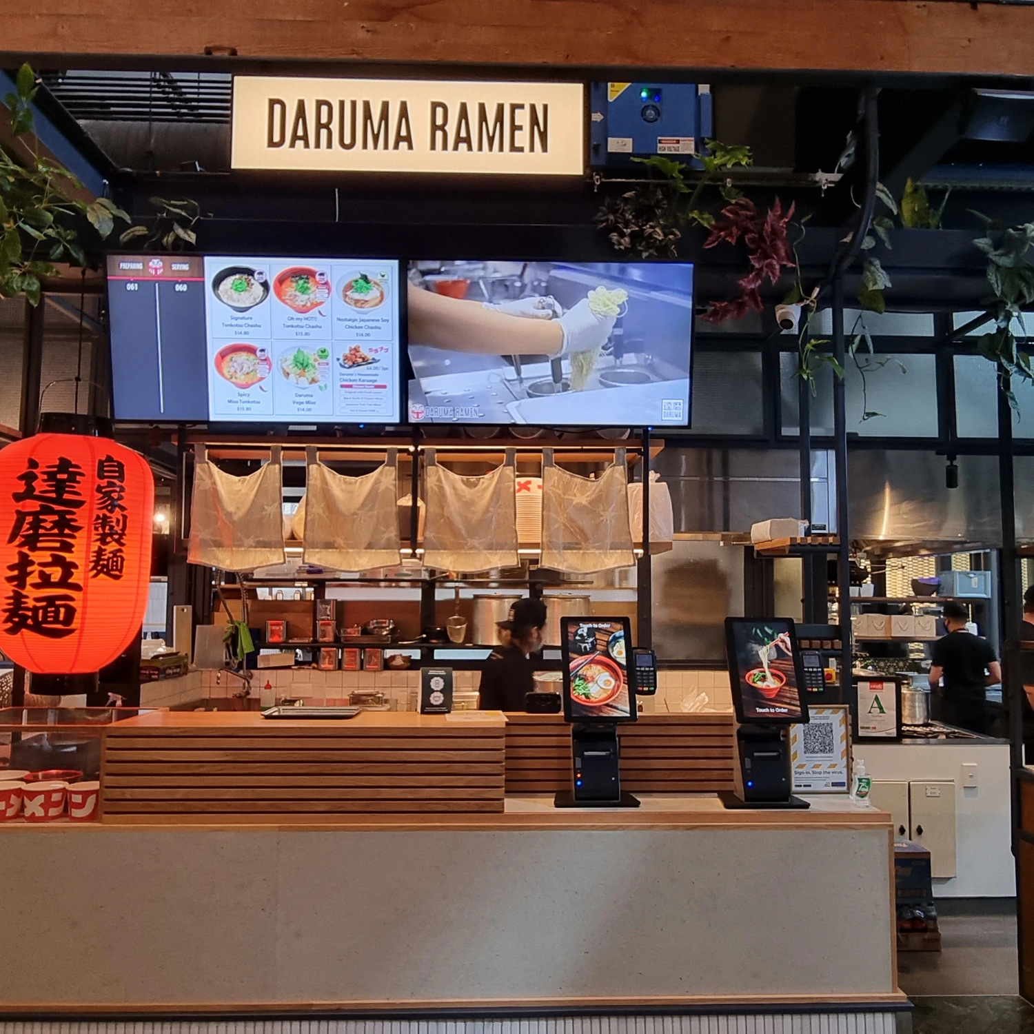 Food order kiosks and kitchen video on large screens